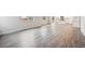 Open-concept living area with wood floors flows into a bright kitchen with a white breakfast bar at 1352 Orchard St, Brighton, CO 80601