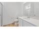 Bright bathroom featuring a glass-enclosed shower, stylish vanity with a white countertop, and tile flooring at 200 Lark Sparrow Way, Bennett, CO 80102