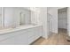 Modern bathroom featuring dual sinks, quartz countertops, and a walk-in glass shower at 200 Lark Sparrow Way, Bennett, CO 80102