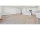 Spacious open-concept living room and kitchen area with modern wood flooring and plenty of natural light at 200 Lark Sparrow Way, Bennett, CO 80102