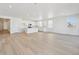 Open-concept living and kitchen area with recessed lighting and plenty of natural light from surrounding windows at 200 Lark Sparrow Way, Bennett, CO 80102