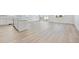 Spacious living area with light wood floors, plenty of natural light, and an open layout, perfect for entertaining at 200 Lark Sparrow Way, Bennett, CO 80102