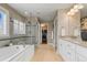 Bright bathroom features a soaking tub, glass-enclosed shower, and double vanity at 14097 Double Dutch Cir, Parker, CO 80134