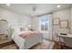 Bright bedroom with white furniture, decorative accents, and natural light from a window at 14097 Double Dutch Cir, Parker, CO 80134