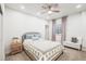 Cozy bedroom with a bed, window, ceiling fan, and side table at 14097 Double Dutch Cir, Parker, CO 80134