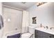 Bathroom featuring a sleek gray vanity, shower/tub combo and neutral-colored decor at 420 Wright St # 101, Lakewood, CO 80228