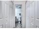 Hallway view into the bathroom with dual closets showing the accessibility and storage space at 420 Wright St # 101, Lakewood, CO 80228