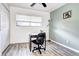 Bright bedroom with a desk, black chair, and wood flooring, offering a great workspace at 420 Wright St # 101, Lakewood, CO 80228