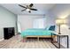 Well-lit bedroom showcasing a ceiling fan, hardwood floors, and bright natural light at 420 Wright St # 101, Lakewood, CO 80228