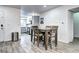 Bright dining room features wood floors, eating area, and view into kitchen at 420 Wright St # 101, Lakewood, CO 80228