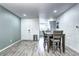 Dining area with sleek flooring, open to the kitchen and living area, and a view of the entryway at 420 Wright St # 101, Lakewood, CO 80228