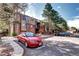Brick and wood condo building with visitor parking and mature landscaping for a welcoming curb appeal at 420 Wright St # 101, Lakewood, CO 80228