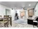 Bright living room featuring a stone fireplace, ceiling fan and sliding glass door to a patio at 420 Wright St # 101, Lakewood, CO 80228