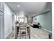 Open-concept living space with dining area, living room with stone fireplace, and modern flooring at 420 Wright St # 101, Lakewood, CO 80228