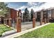 Community pool surrounded by brick and iron fencing, with well-maintained landscaping at 420 Wright St # 101, Lakewood, CO 80228