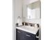 Cozy bathroom featuring a modern vanity with a stylish backsplash and ample mirror space at 1000 N Ogden St, Denver, CO 80218