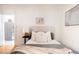 Bright bedroom with a comfortable bed, soft pillows, and a view into the kitchen at 1000 N Ogden St, Denver, CO 80218