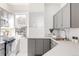 Well-lit kitchen with gray cabinets, stainless steel appliances, and a subway tile backsplash at 1000 N Ogden St, Denver, CO 80218