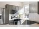 Modern kitchen featuring stainless steel appliances, gray cabinets, and ample counter space at 1000 N Ogden St, Denver, CO 80218