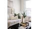 Close up of living room featuring a white sofa, decor, plants, and natural light from the window at 1000 N Ogden St, Denver, CO 80218