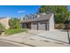 Two-story home with gray siding, brick accents, and a two-car garage at 5809 E Caley Dr, Centennial, CO 80111