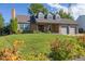 Brick ranch home with landscaped yard and attached two-car garage at 5809 E Caley Dr, Centennial, CO 80111
