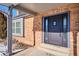 Dark stained front door entry with sidelights and brick exterior at 5809 E Caley Dr, Centennial, CO 80111