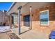 Covered front porch with brick columns and a blue bench at 5809 E Caley Dr, Centennial, CO 80111