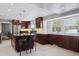 Renovated kitchen with island, stainless steel appliances, and dark wood cabinetry at 5809 E Caley Dr, Centennial, CO 80111