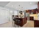 Spacious kitchen with island, stainless steel appliances, and dark wood cabinetry at 5809 E Caley Dr, Centennial, CO 80111