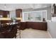Kitchen features dark wood cabinets, a breakfast bar, and a sunny window at 5809 E Caley Dr, Centennial, CO 80111