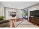 Open living room with hardwood floors, a view of the kitchen and backyard access at 5809 E Caley Dr, Centennial, CO 80111