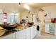 Bathroom boasts dual vessel sinks atop granite counters with white cabinetry and whimsical wall decor at 20292 E 47Th Ave, Denver, CO 80249