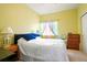 Bright bedroom featuring neutral carpet, a ceiling fan and colorfully decorated window with sheer curtains at 20292 E 47Th Ave, Denver, CO 80249