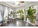 Bright breakfast nook with a glass table, barstool seating, and open space with an abundance of plants at 20292 E 47Th Ave, Denver, CO 80249