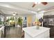 Bright kitchen with an island, stainless steel appliances, and an open view to the second level at 20292 E 47Th Ave, Denver, CO 80249