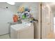 Functional laundry room with a washing machine, dryer, storage shelves, and plenty of storage space at 20292 E 47Th Ave, Denver, CO 80249