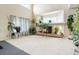 Open living room featuring a cozy fireplace, large windows, and neutral carpet flooring at 20292 E 47Th Ave, Denver, CO 80249