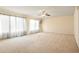 Expansive living room with neutral carpet, bright lighting, and large windows allowing natural light at 20292 E 47Th Ave, Denver, CO 80249