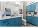 Bright bathroom with blue cabinets, a spacious quartz countertop and modern fixtures at 290 W 12Th Ave # 303, Denver, CO 80204
