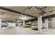 Well lit garage with multiple parking spaces, garage doors and visible piping at 290 W 12Th Ave # 303, Denver, CO 80204