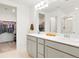 Elegant bathroom with double vanity, spacious mirrors, and a walk-in closet at 21528 E 59Th Pl, Aurora, CO 80019