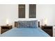 Inviting bedroom featuring a plush pillow, side tables with lamps, and decorative wall art at 21528 E 59Th Pl, Aurora, CO 80019
