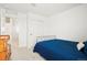 Cozy bedroom with neutral carpet and a minimalist bed frame; closet and hall access visible at 21528 E 59Th Pl, Aurora, CO 80019