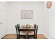 Bright dining area features wood floors, modern art, and a view of the backyard at 21528 E 59Th Pl, Aurora, CO 80019
