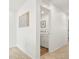 Hallway with neutral carpet, art on the wall, and laundry area with stacked washer and dryer for convenience at 21528 E 59Th Pl, Aurora, CO 80019