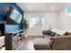 Comfortable living area with a large window and a cozy sectional sofa at 21528 E 59Th Pl, Aurora, CO 80019