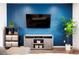 Stylish living room showcasing modern decor and a serene blue accent wall at 21528 E 59Th Pl, Aurora, CO 80019