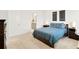 Spacious main bedroom featuring a comfortable bed, and an adjacent bathroom at 21528 E 59Th Pl, Aurora, CO 80019