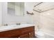 Bright bathroom features a single sink vanity and shower-over-tub at 4950 Homestead Pl # 23, Thornton, CO 80229